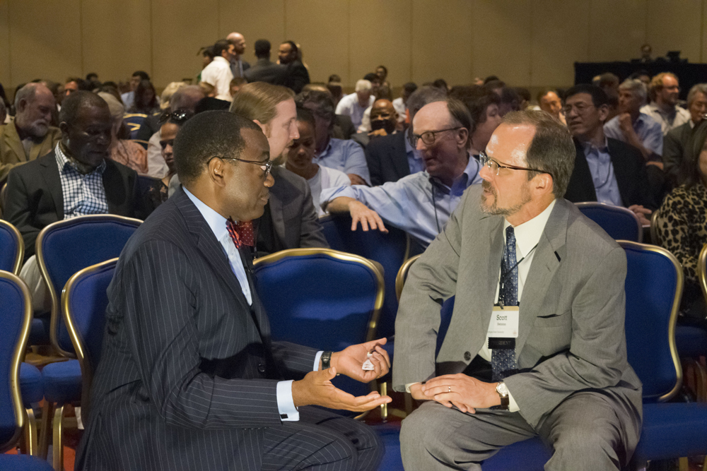 Scott Swinton conversing with President Akin Adesina before the keynote address at the conference.