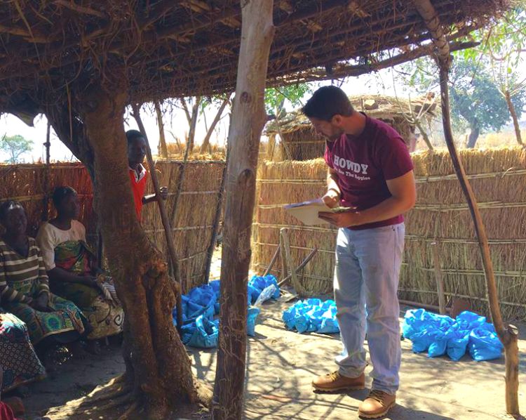 Tim Silberg, CSUS graduate, talking with community members in Malawi.