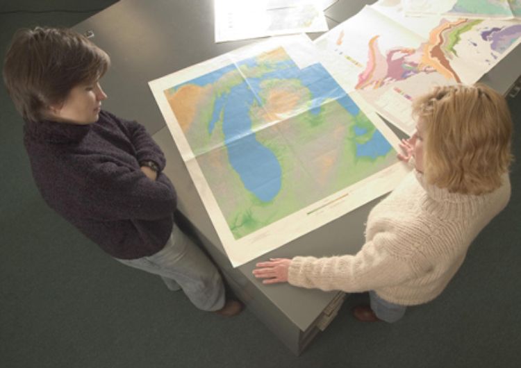 Patricia Soranno (left) and Mary Bremigan examine a map of some of Michigan's freshwater resources