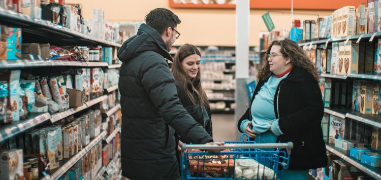 Grocery shoppers chat in an aisle