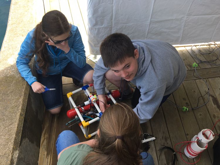 Youth building an underwater remotely operated vehicle