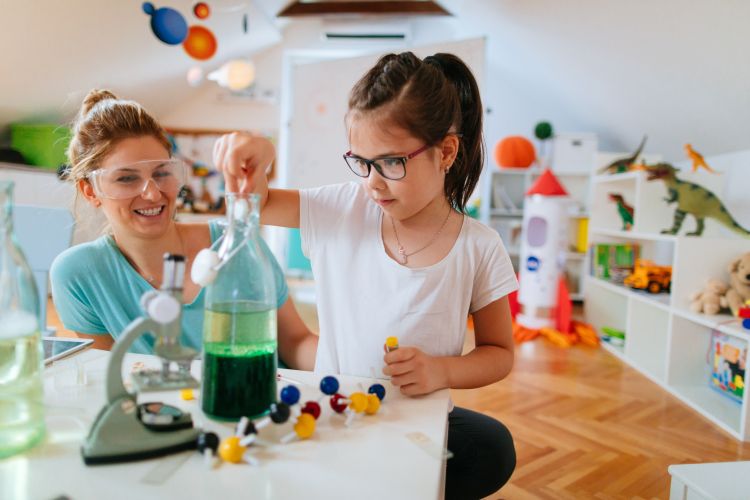 A young girl and her mother do a science experiment together