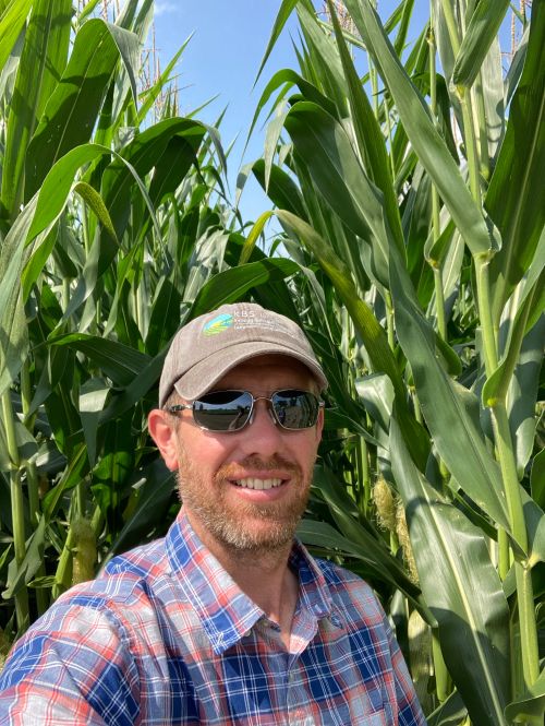 KBS LTAR Associate Director Brook Wilke poses in front of the 2021 corn crop