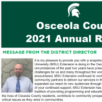 front cover of the annual report with green background, title in white, bold font and a note by the district director
