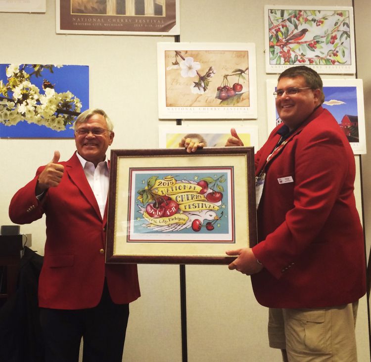 Jim Flore, horticulture professor, receives the award from David Barr, president of the National Cherry Festival.