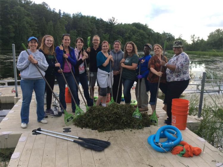 Educators learn about watersheds by kayak while providing aquatic stewardship service, removing invasive European Frogbit. Photo credit: Michigan Sea Grant