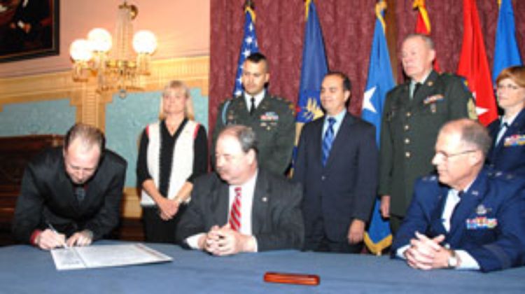 Adrian Blow signs the Michigan Military Family and Community Covenant on Nov. 12, 2008 at the state Capitol.