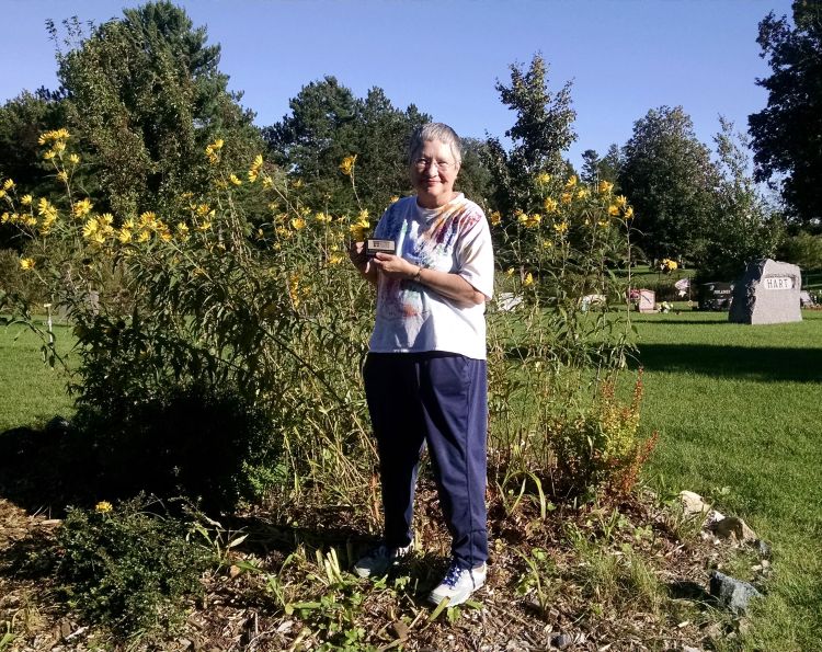 Jeannette Hauver with one of her many flower gardens at Park Cemetery. Photo: Rebecca Krans, MSU Extension