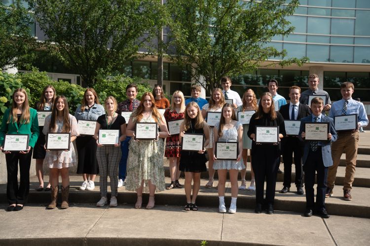Winners of the 2023 Michigan 4-H State Awards holding up their plaques outside the Wharton Center.