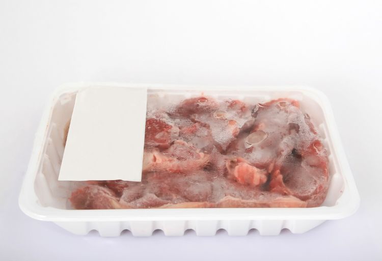 Meat in a plastic container.
