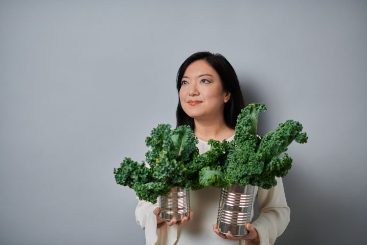 Felicia Wu holding a can of kale.
