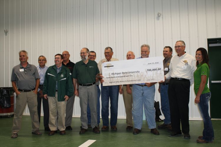 Representatives from MSU and the Michigan Wheat Program commemorate the contribution with a large check.