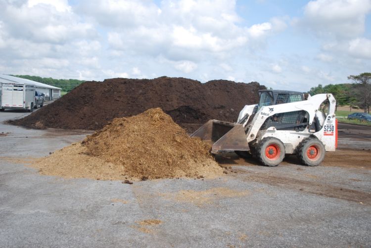 Skid steer working with compost.