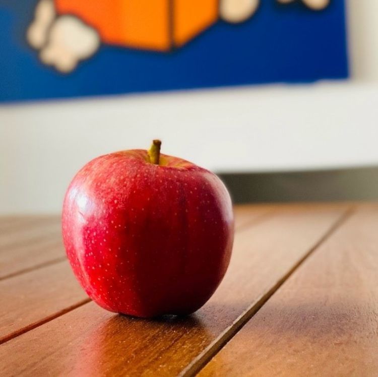An apple on a table.