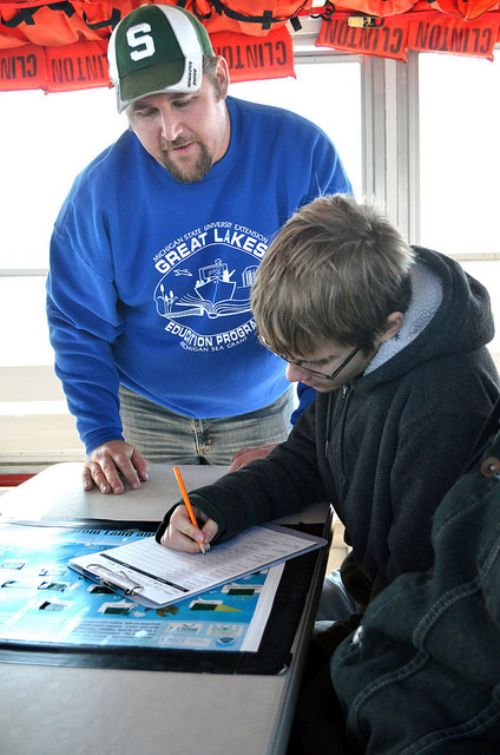 Michigan Sea Grant program instructor Justin Selden spends a lot of time working with students while on the schoolship and touring lakes St. Clair and Detroit. Photo: Michigan Sea Grant