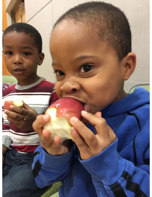 Children's Center student eating an apple.