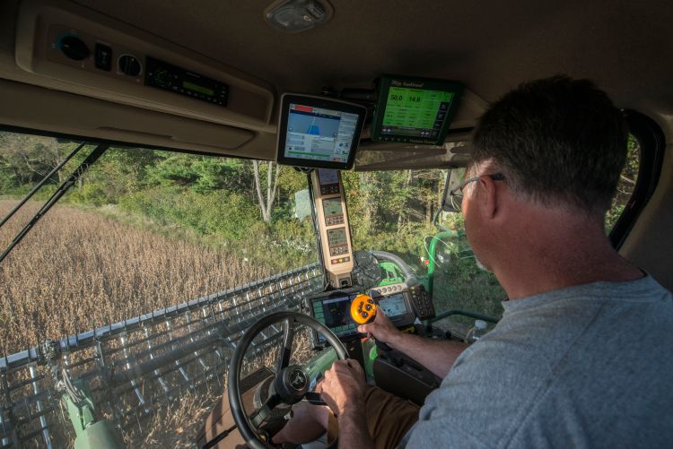 Jeff Sandborn monitors his GPS equipment while harvesting
