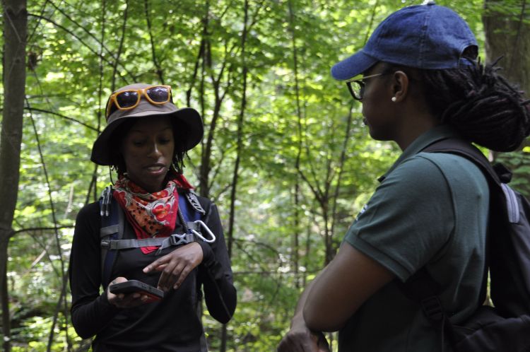MSU Forestry graduate student Alex White talks with Forestry professor Asia Dowtin in Bancroft Park. Dowtin is mentor in the CANR Multicultural Apprenticeship Program.