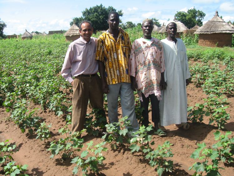 Karim Maredia, left, joins a farm tour in Africa.