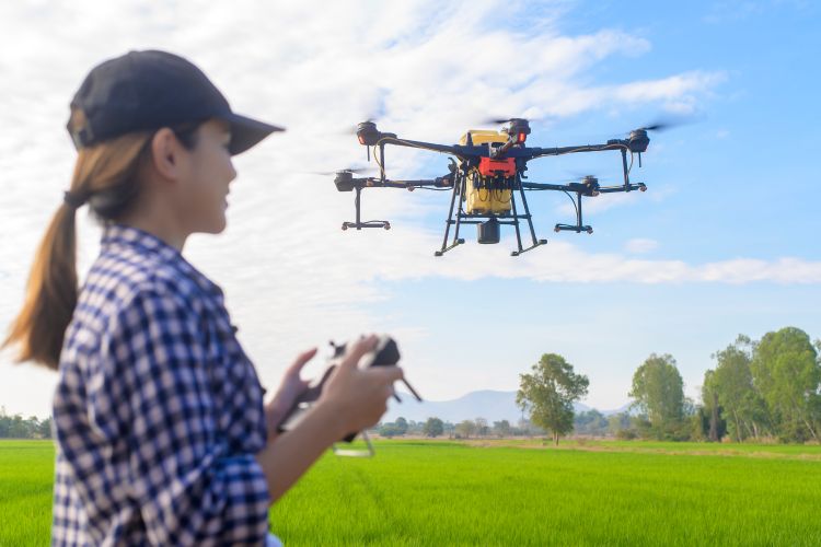 Youth using remote to control a drone.