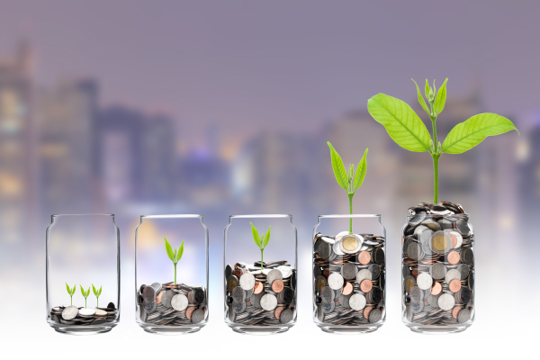 mix coins and seed in clear bottle on cityscape photo blurred cityscape background,Business investment growth concept