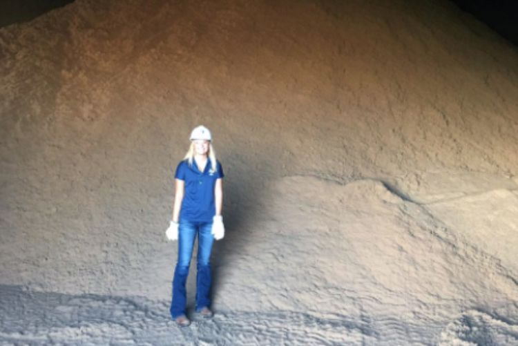 Madi Heath at standing in front of grain at her summer internship.