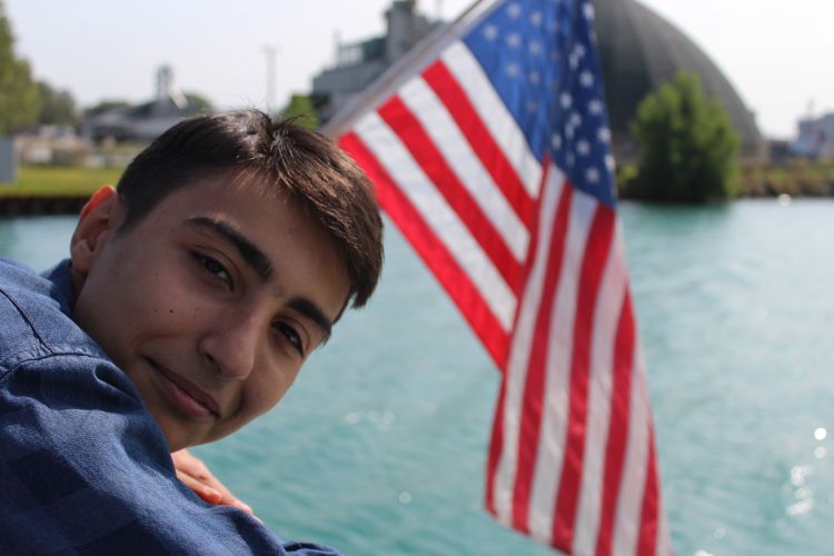 Artyom, a 4-H academic year-long exchange student from Armenia, is enjoying a cruise on Lake Huron during his Michigan exchange experience. Photo by D’Ann Rohrer, MSU Extension.