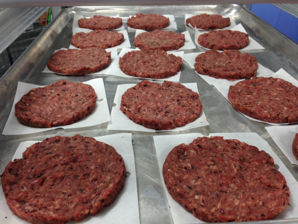 Blended beef and bean burger patties laid out on a metal tray