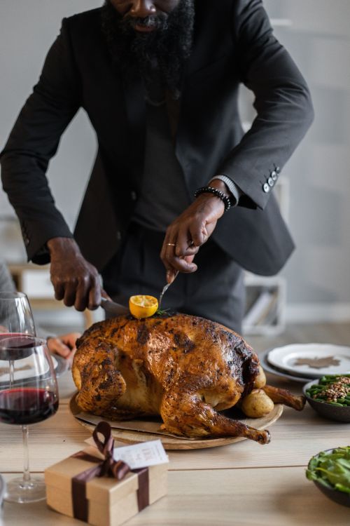 A person carving a turkey.