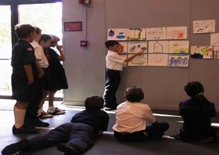 Children learning from pictures hung up on the walls.