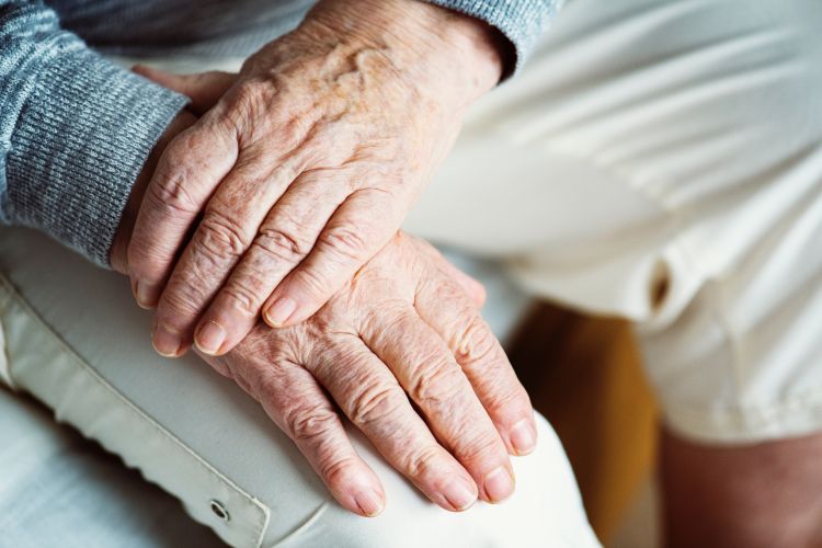 An older person's hands clasped.