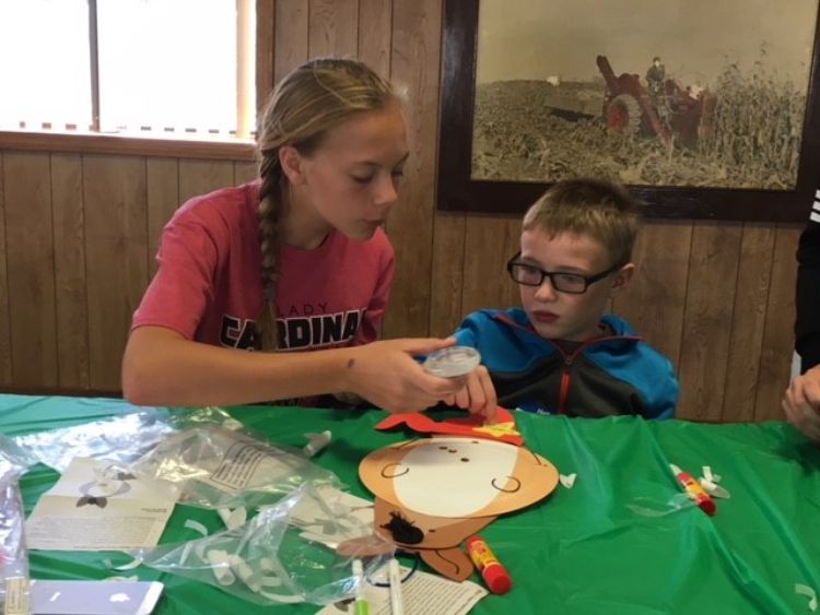 4-H volunteer, Allison Miller, teaches a 4-H PEP student a new craft. Photo by Connie Lange, MSU Extension.