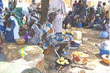 women at a market preparing food