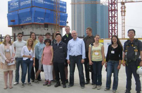 2012 Construction Management Study Abroad Group at a high tower construction site in Asia.
