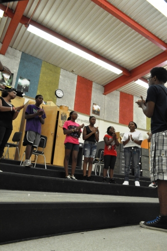 4-H youth rehearse gospel songs written for their play.