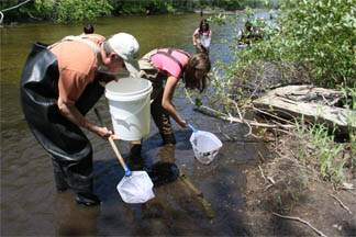 Students taking water samples in the river.