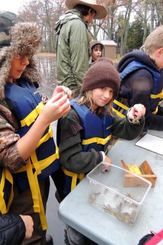 Students examining cray fish samples image.