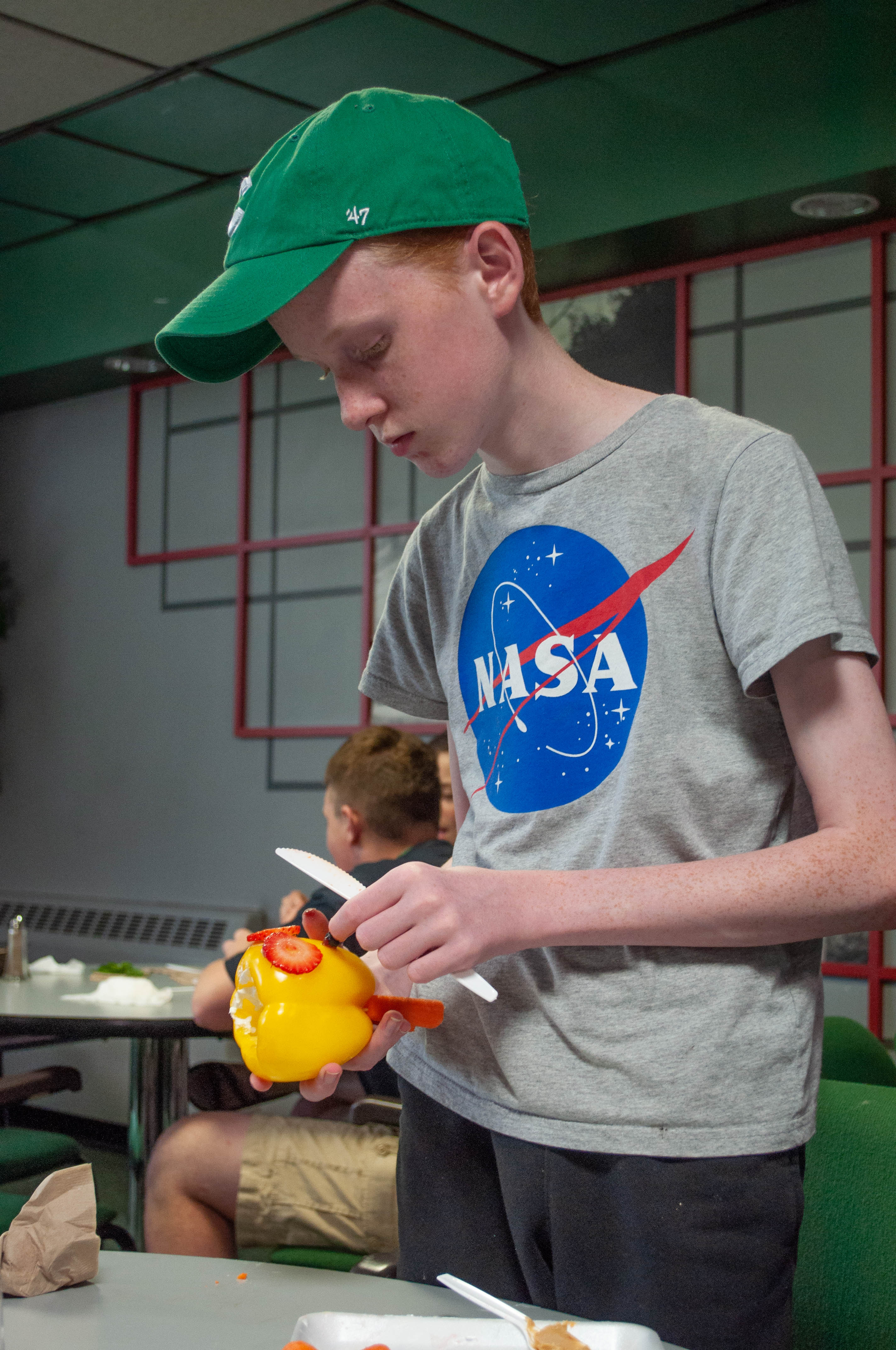 Child creating vegetable art