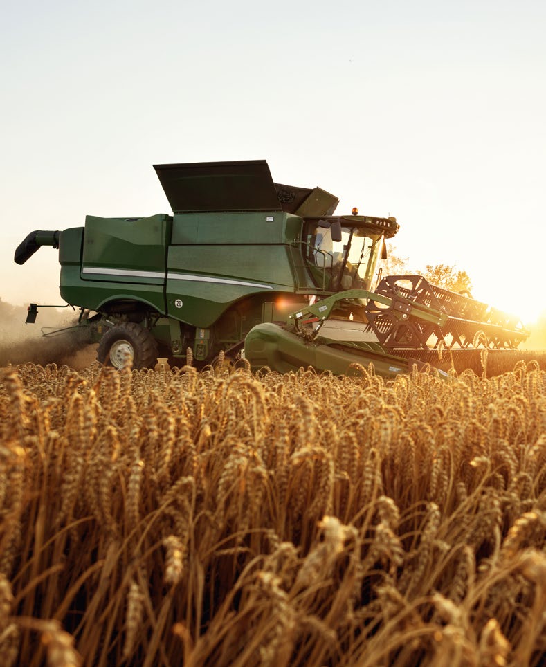 Combine going through a field