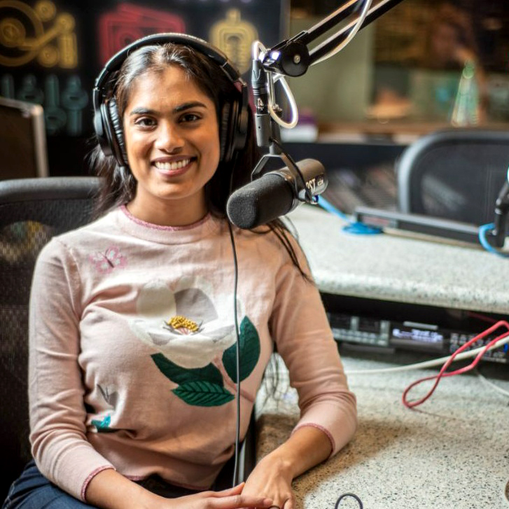 Headshot of Chelsie Boodoo with microphone