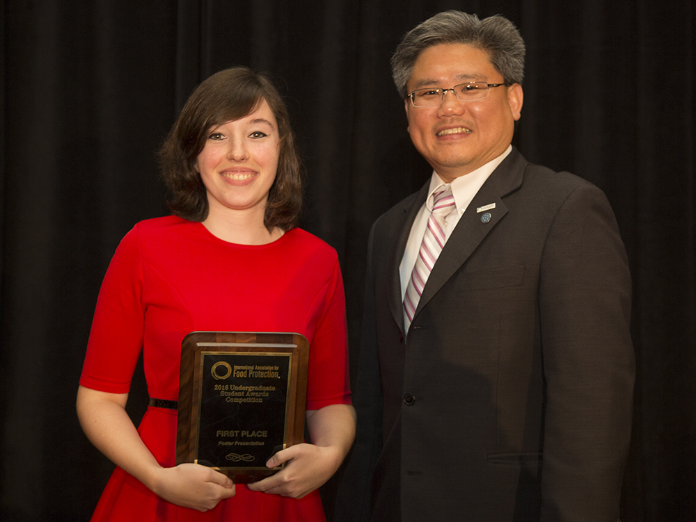 Photo of -	Sarah Buchholz receiving 1st-place in the undergraduate poster competition at IAFP 2016, presented by IAFP Program Chair-Elect, Dr. Alvin Lee.