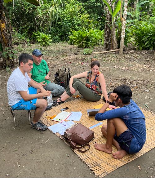 Photo of Zanabria (in green) and Cooper (multi-color) in Shipetiari for the Bosques + Gente project, February 2022