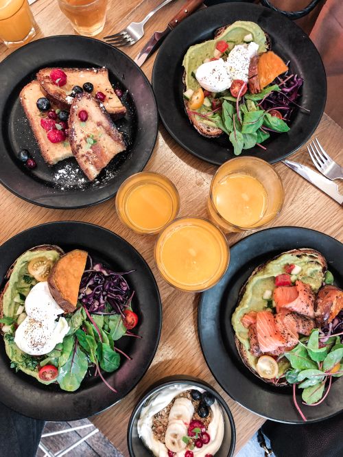 A variety of healthy prepared dishes sitting on a wooden table.