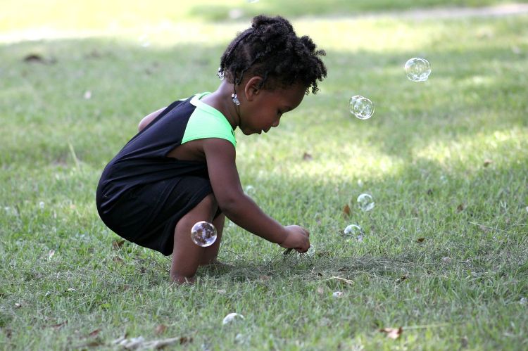 Using an idex finger to pop a bubble shows developing pincer coordination skills.