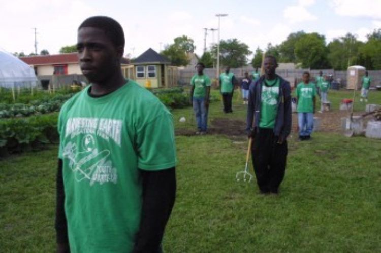 Young people in the field at Harvesting Earth Farm in Flint, Michigan.