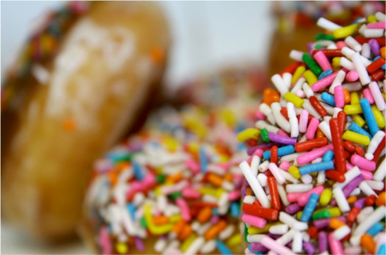 The sprinkles on this doughnut represent a pattern that makes you feel like you could reach out and pick them right off the photo.