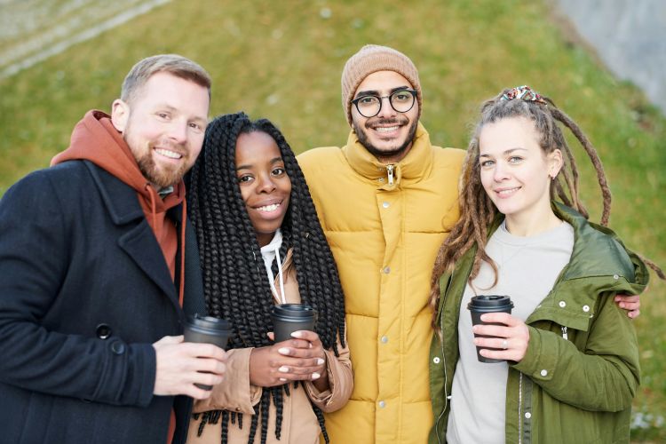 A group of friends posing with coffee.