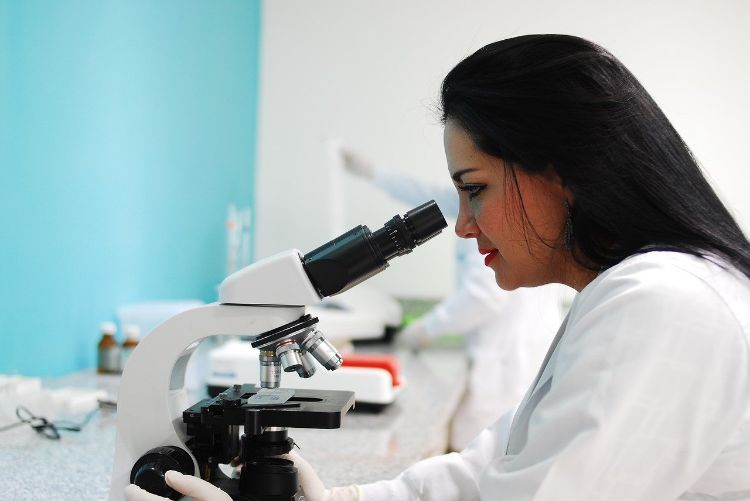 Woman looking into a microscope