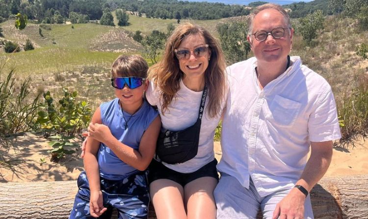 A family of three sitting for a photo.
