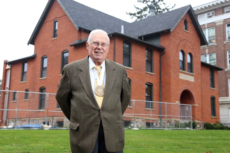 Gary L. Seevers stands in front of Cook Hall.